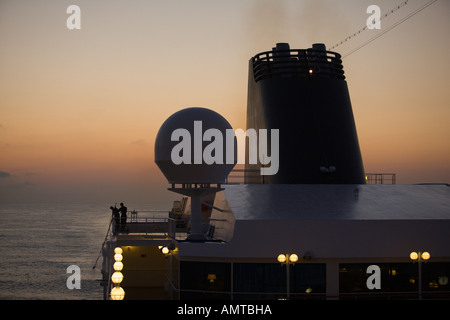 Colorato sunrise guardando attraverso la poppa sul ponte superiore di passeggeri delle navi da crociera in camicia l'Oceano Pacifico Foto Stock