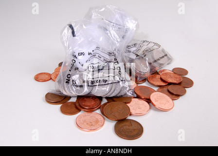 Monete nei sacchetti di modifica. Foto Stock