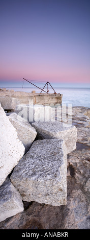 Cava di grandi blocchi di pietra e rosso ruggine gru vicino a Portland Bill lighthouse, contea di Dorset, Inghilterra, Regno Unito. Foto Stock