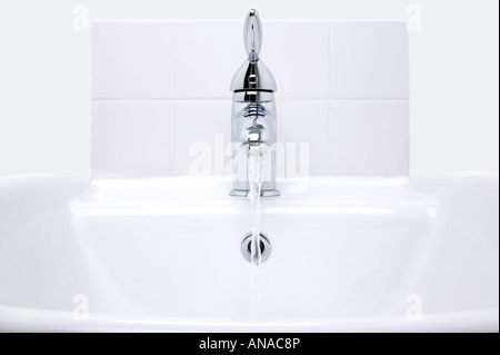 Bianco ceramica moderna lavabo e chrome acqua di rubinetto in esecuzione Foto Stock