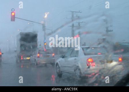 Visione offuscata come visto attraverso la parte anteriore del parabrezza auto in un giorno di pioggia in Israele Foto Stock