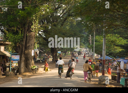 Myanmar Birmania settentrionale dello Stato Shan Hsipaw vista della strada principale con il traffico locale e gli alberi di grandi dimensioni Foto Stock