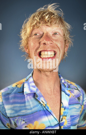 Crazy biondo uomo in Hawaii-shirt rendendo grimace Foto Stock