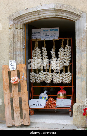 Le trecce di aglio e sacchi di cipolle in vendita Bastide d'Armagnac Francia Foto Stock