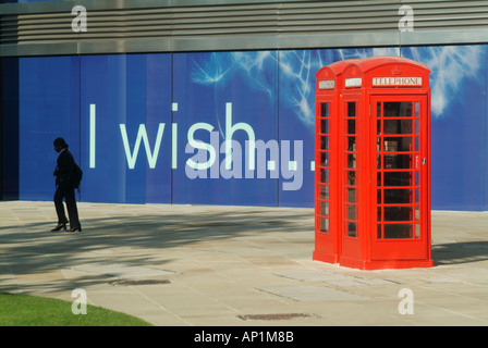 Londra palizzata pannelli attorno ad una quasi completa blocco ufficio segno scritto con desidero slogan telefono rosso pedonale scatole Foto Stock