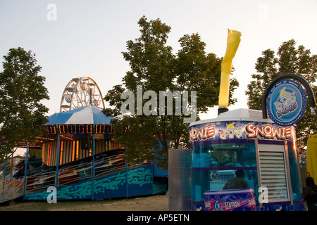 Qui ci sono tre luoghi comuni a una fiera di Stato o il parco divertimenti: una ruota panoramica Ferris, un 'pinning' park & ride un snowcone stand. Foto Stock