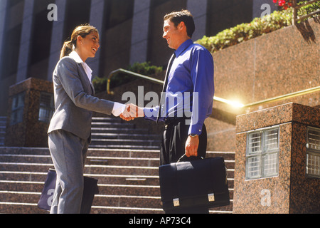 Imprenditore e la donna stringono le mani sui passi di Los Angeles Foto Stock