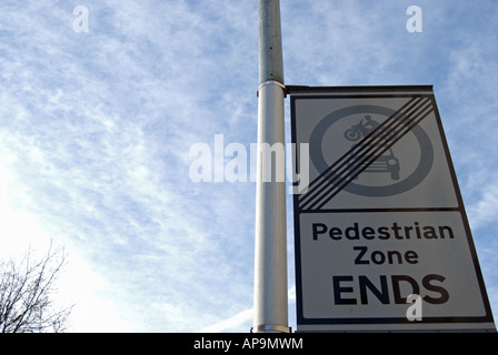 Visto contro un cielo blu, questa strada britannico segno attaccato ad un lampione indica la fine di una zona pedonale Foto Stock
