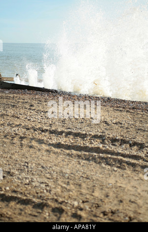 Onde alte che colpiscono le difese del mare di legno in inverno a Climping Beach, West Sussex, Inghilterra, Regno Unito Foto Stock