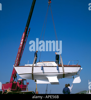 Piccolo keeled sentina yacht che viene sollevato da un mobile gru idraulica in un cantiere navale, Grimsby, Humberside, Inghilterra, Regno Unito. Foto Stock