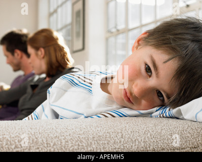 Ragazzo (3-6) con i genitori sul lettino (verticale). Foto Stock