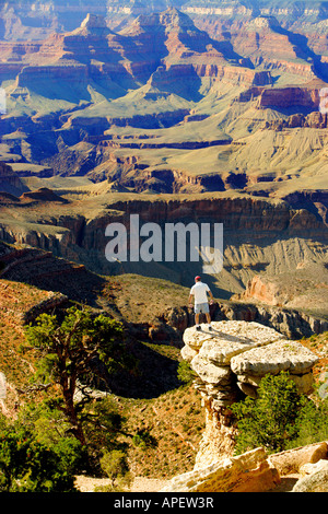 Uomo in piedi sul bordo della roccia a strapiombo affacciato sul Grand Canyon. Foto Stock