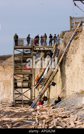 Gli spettatori a Birling Gap guardano in basso verso la spiaggia e il carico di legname da colpite il principe di ghiaccio. Foto Stock