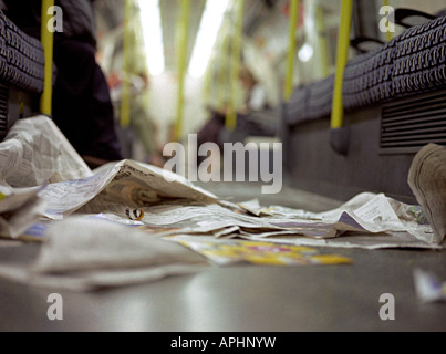 Spazzatura sul pavimento del tubo a Londra da giornali gratuiti Foto Stock