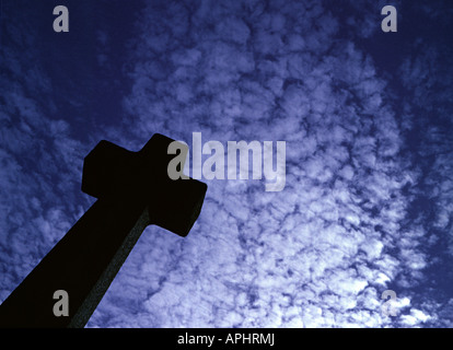 Una croce di un oggetto contrassegnato per la rimozione definitiva in un cimitero contro un blu cielo sgombro Foto Stock