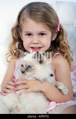 Bambina gioca con siamesse gattino Foto Stock