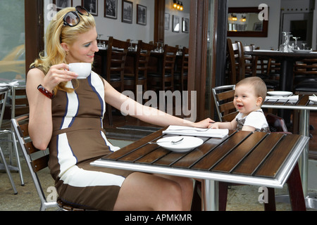 Metà adulto madre con bambino ragazza nel café Foto Stock
