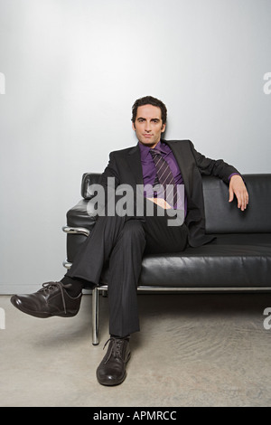 Imprenditore seduto sul divano Foto Stock