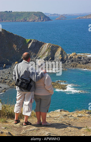 Giovane guardando la vista dalla Pointe de Minard vicino Plouézec, Côtes d'Armor Bretagna, Francia Foto Stock