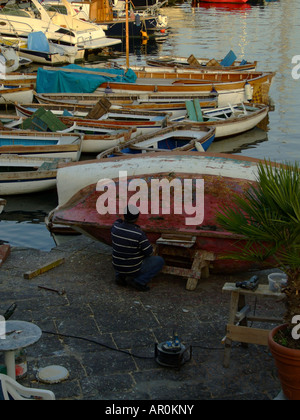 Fisherman lavorando la riparazione di barca a vela a Napoli Campania Italia Foto Stock