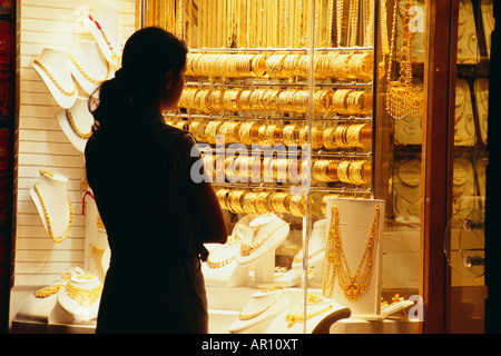 Una donna guarda la gioielleria visualizzato in una gioielleria Foto Stock