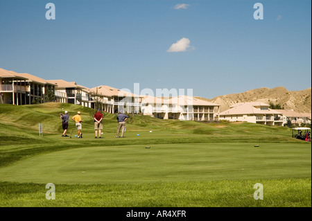 Gli amanti del golf sul green di colpire alcune palline da golf Foto Stock