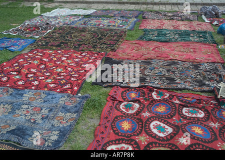 Una collezione di ricamati a mano tessile Suzani sparsi sul terreno in vendita Shakhrisabz (Shakrisabs) - Uzbekistan Foto Stock