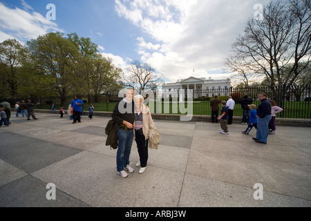 Anziani turisti dall'Europa in posa davanti alla Casa Bianca, Penn Ave Washington DC. Foto Stock