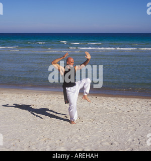 Professional Tai Chi e Kong fu istruttore impresa allenamento sulla spiaggia di Maiorca, isole Baleari, Spagna. Foto Stock