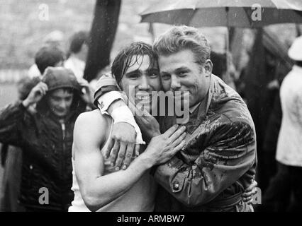 Calcio, Regionalliga Ovest, 1967/1968, Stadio am Uhlenkrug a Essen, ETB Schwarz-Weiss Essen contro Bayer Leverkusen 3:3, gioendo giocatore di football, Friedhelm Strelczyk (Leverkusen) sinistro abbracciato da un fortunato tifoso di calcio Foto Stock