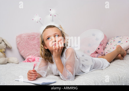 Ragazza vestita come fata iscritto lista dei regali di Natale Foto Stock