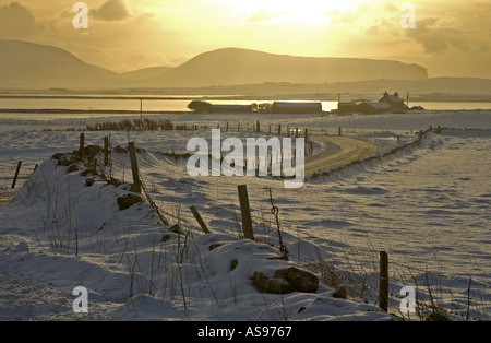 Dh Loch di Harray HARRAY ORKNEY bronzo crepuscolo campi innevati e casa Loch Harray e Stenness Hoy colline Foto Stock