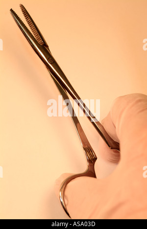 La mano di presa di un paio di pinze chirurgiche Foto Stock