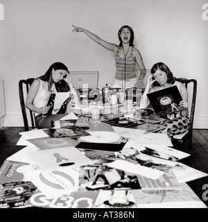 Tre ragazze adolescenti ascoltando musica e guardando i record Foto Stock