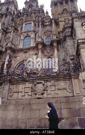 Nun oltrepassando la magnifica cattedrale di Santiago de Compostela Galizia Spagna Foto Stock