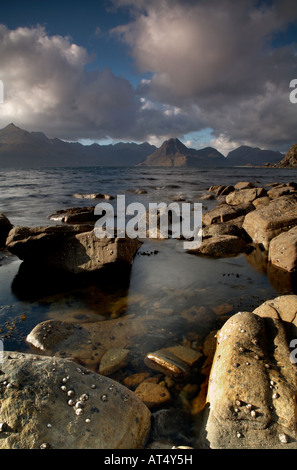 Nuvole temporalesche sopra il nero montagne Cuillin sul loch scavaig sull'isola di Skye dalla spiaggia rocciosa a Elgol village Foto Stock