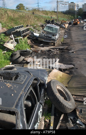 Abbandonate le vetture disastrate e spazzatura. Marshgate Lane, Stratford, Londra, Inghilterra Foto Stock
