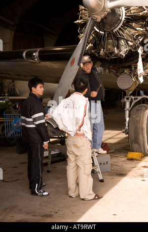 Due Asian Teen Boys ascoltare curatore raccontano di piano al Carolinas Aviation Museum in Charlotte NC USA Foto Stock