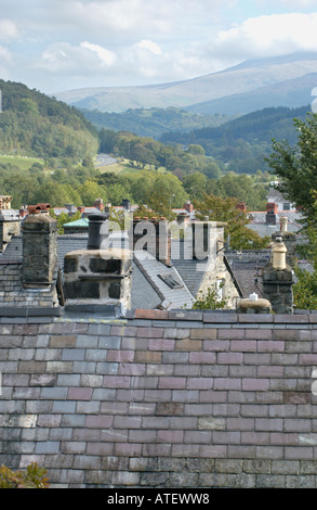 Vista sui tetti di ardesia verso montagne distanti in lingua gallese città Gwynedd a Dolgellau Galles del Nord Regno Unito Foto Stock