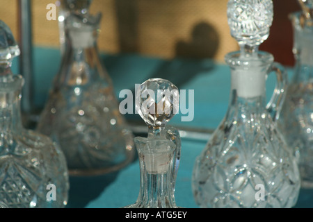 Vetro di vecchie bottiglie di profumo sul display in un negozio di antiquariato finestra. Foto Stock