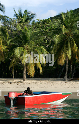 Un locale si rilassa nella sua barca al largo dell'isola di Mayreau St Vincent e Grenadine West Indies Foto Stock