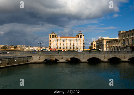 Il Ponte Nuovo che collega l'isola di Ortigia per la cittadina principale di Siracusa, Sicilia, Italia, con gli ornati Post Office dietro Foto Stock
