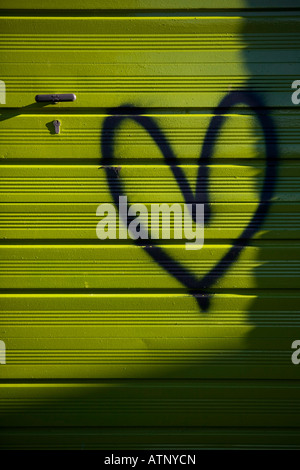 Amore spruzzi di cuore dipinta su un garage verde Foto Stock