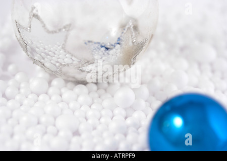 Christmas baubles reflecting snow Foto Stock