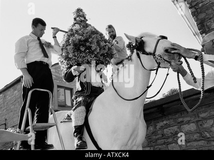 Una ghirlanda di fiori collocato sopra la testa di un uomo in Garland giorno processione in Castleton Derbyshire Foto Stock