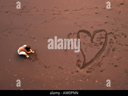 Amore cuore disegnato nella sabbia sulla spiaggia Foto Stock