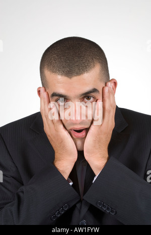 Business man mano sulla faccia in stato di shock Foto Stock