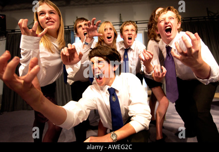 Gli adolescenti in uniformi di scuola in un dramma di classe Foto Stock