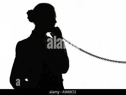 Donna al telefono, silhouette Foto Stock