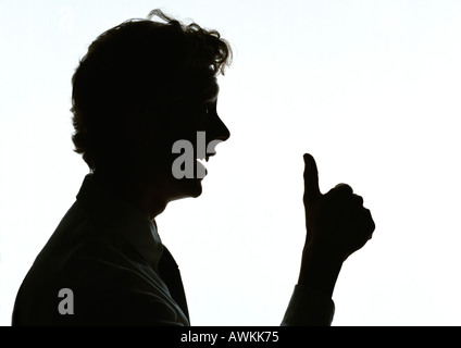 L uomo dando Thumbs up, silhouette. Foto Stock